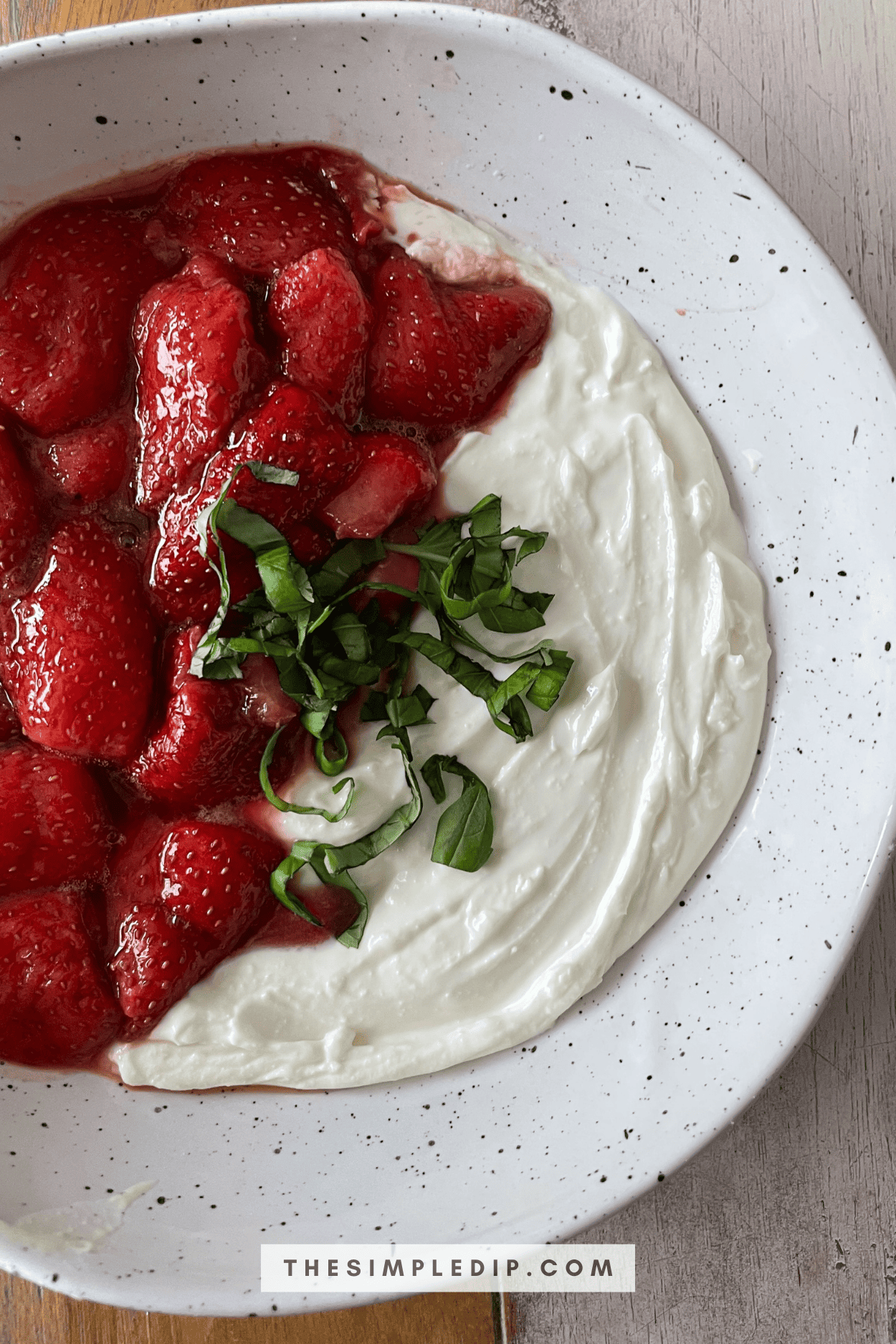 This Whipped Feta with Balsamic Roasted Strawberries features vibrant red berries, a creamy whipped feta/ricotta base, and is topped with basil ribbons. It's as bright and colorful as it is flavorful.